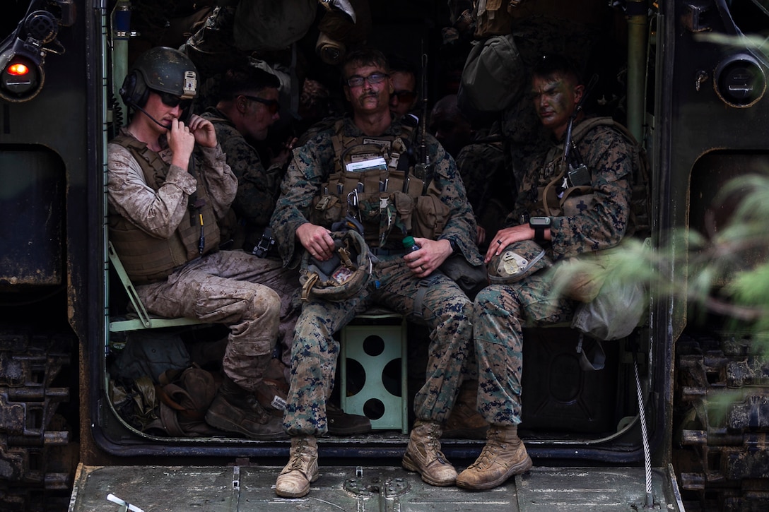 Marines with Echo Company, Battalion Landing Team, 2nd Battalion, 5th Marines, take a short break inside an Assault Amphibious Vehicle during a mechanized assault as part of the 31st Marine Expeditionary Unit’s MEU Exercise, near Ginoza Village, Okinawa, Japan, June 28, 2018. Marines and Sailors with Echo Company performed the final training event of MEUEX, an assault launched from Camp Schwab and targeting Combat Town, part of Okinawa’s Central Training Area. Marines with Echo Company, the mechanized assault element with BLT 2/5, partner with AAV crews to perform raids and assaults launched from the sea. MEUEX is the first in a series of three pre-deployment training events that prepare the 31st MEU to deploy at a moment’s notice. The 31st MEU, the Marine Corps’ only continuously forward-deployed MEU, provides a flexible force ready to perform a wide-range of military operations.