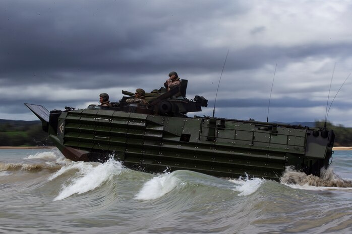 Marines with Echo Company, Battalion Landing Team, 2nd Battalion, 5th Marines, riding Assault Amphibious Vehicles, head toward the shore during a mechanized assault as part of the 31st Marine Expeditionary Unit’s MEU Exercise, near Ginoza Village, Okinawa, Japan, June 28, 2018. Marines and Sailors with Echo Company performed the final training event of MEUEX, an assault launched from Camp Schwab and targeting Combat Town, part of Okinawa’s Central Training Area. Marines with Echo Company, the mechanized assault element with BLT 2/5, partner with AAV crews to perform raids and assaults launched from the sea. MEUEX is the first in a series of three pre-deployment training events that prepare the 31st MEU to deploy at a moment’s notice. The 31st MEU, the Marine Corps’ only continuously forward-deployed MEU, provides a flexible force ready to perform a wide-range of military operations.