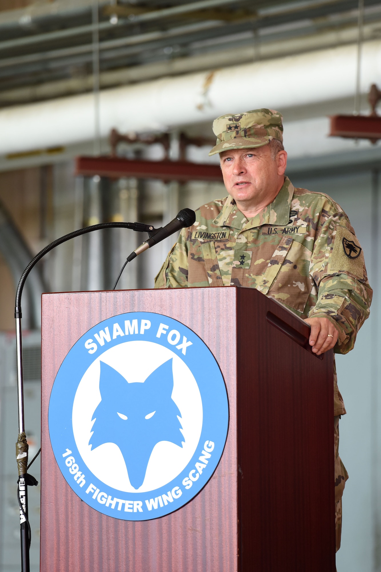 U.S. Army Maj. Gen. Robert E. Livingston Jr., the Adjutant General of the South Carolina National Guard, addresses Airmen of the 169th Fighter Wing during a change of command ceremony at McEntire Joint National Guard Base, S.C., June 23, 2018. Col. Nicholas Gentile Jr. relinquishes command of the 169th Fighter Wing to Col. Akshai Gandhi. (U.S. Air National Guard photo by Ashleigh Pavelek)