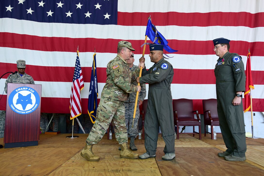 U.S. Airmen of the 169th Fighter Wing and the South Carolina Air National Guard, assemble for a change of command ceremony at McEntire Joint National Guard Base, S.C., June 23, 2018. Col. Nicholas Gentile Jr. relinquishes command of the 169th Fighter Wing to Col. Akshai Gandhi. (U.S. Air National Guard photo by Senior Airman Megan R. Floyd)