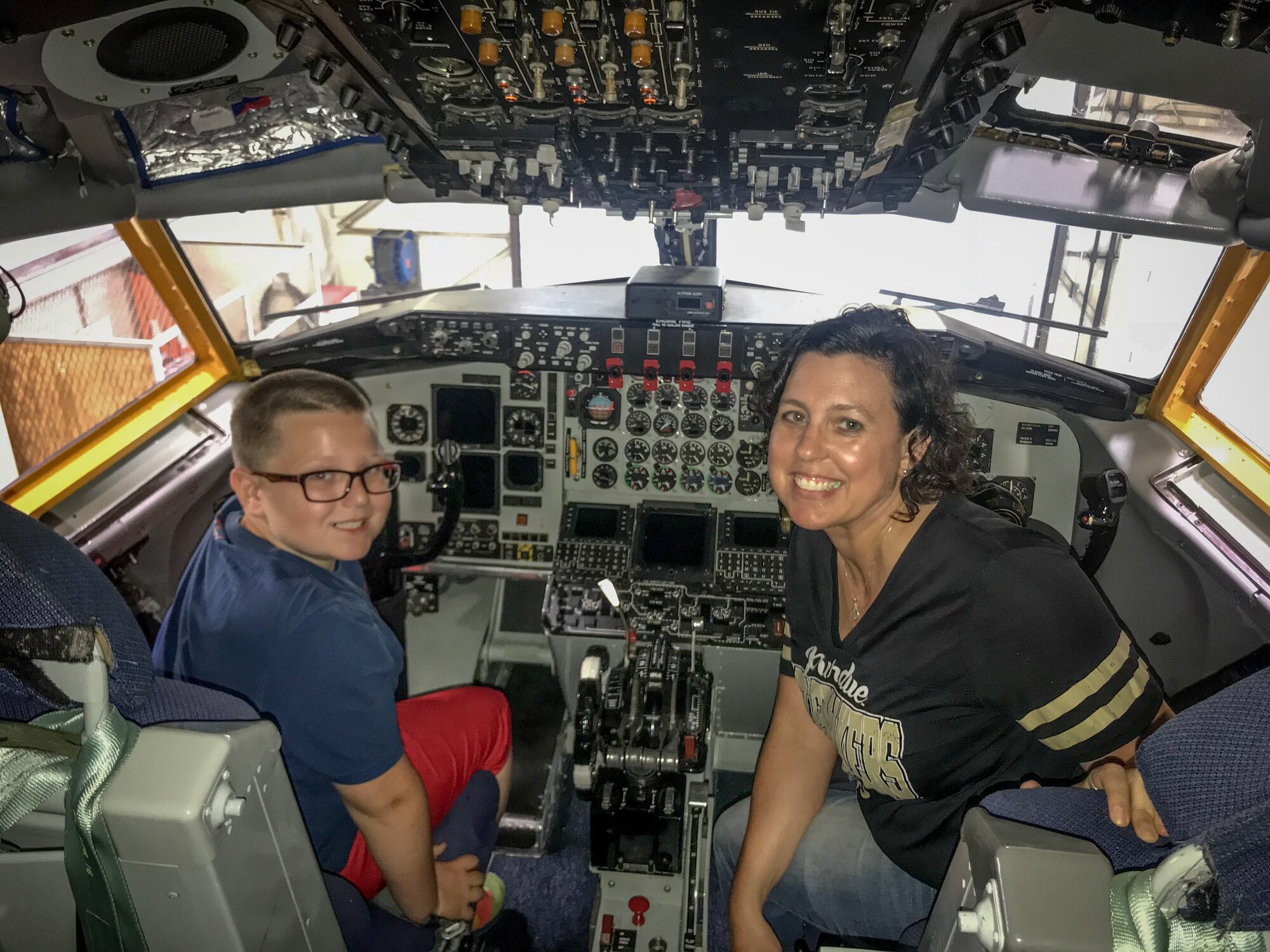 Corbin and Gretchen Bollhoefer pose inside the cockpit of a KC-135R Stratotanker June 27, 2018 at Grissom Air Reserve Base, Indiana. During a tour of the base, the Aircrew from the 434th Air Refueling Wing taught them the basics of flying and operating systems on the aircraft. (U.S. Air Force photo/Senior Airman Cali Elliott)