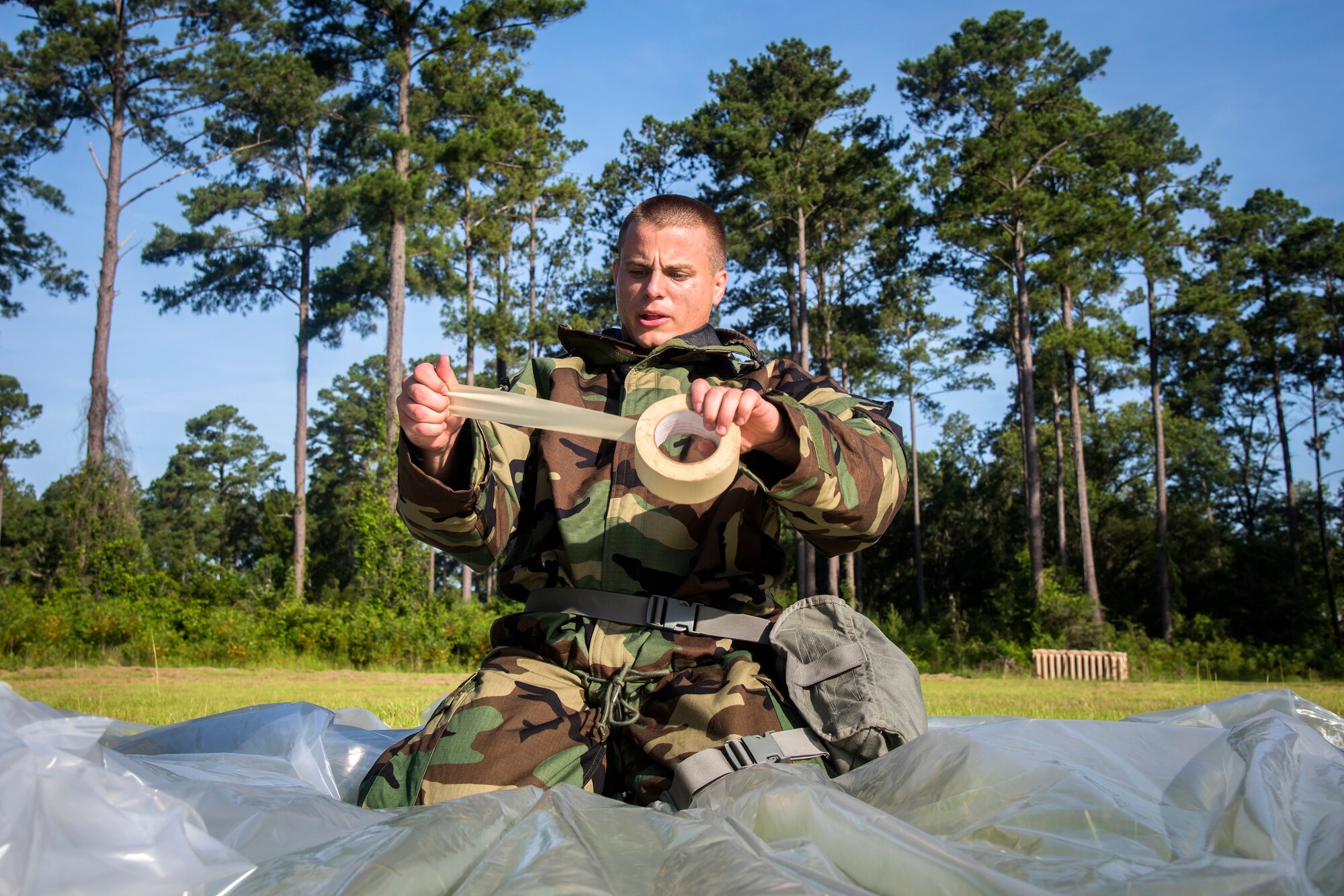 An Airman from the 23d Civil Engineer Squadron, pulls tape for a plastic covering during a Chemical, Biological, Radiological, Nuclear and Explosive (CBRNE) Olympics, June 21, 2018, at Moody Air Force Base, Ga.  Moody held its first CBRNE Olympics to further Airmen’s overall knowledge on all of the aspects of CBRNE through a new method that was meant to establish a sense of competition and camaraderie. (U.S. Air Force photo by Airman 1st Class Eugene Oliver)