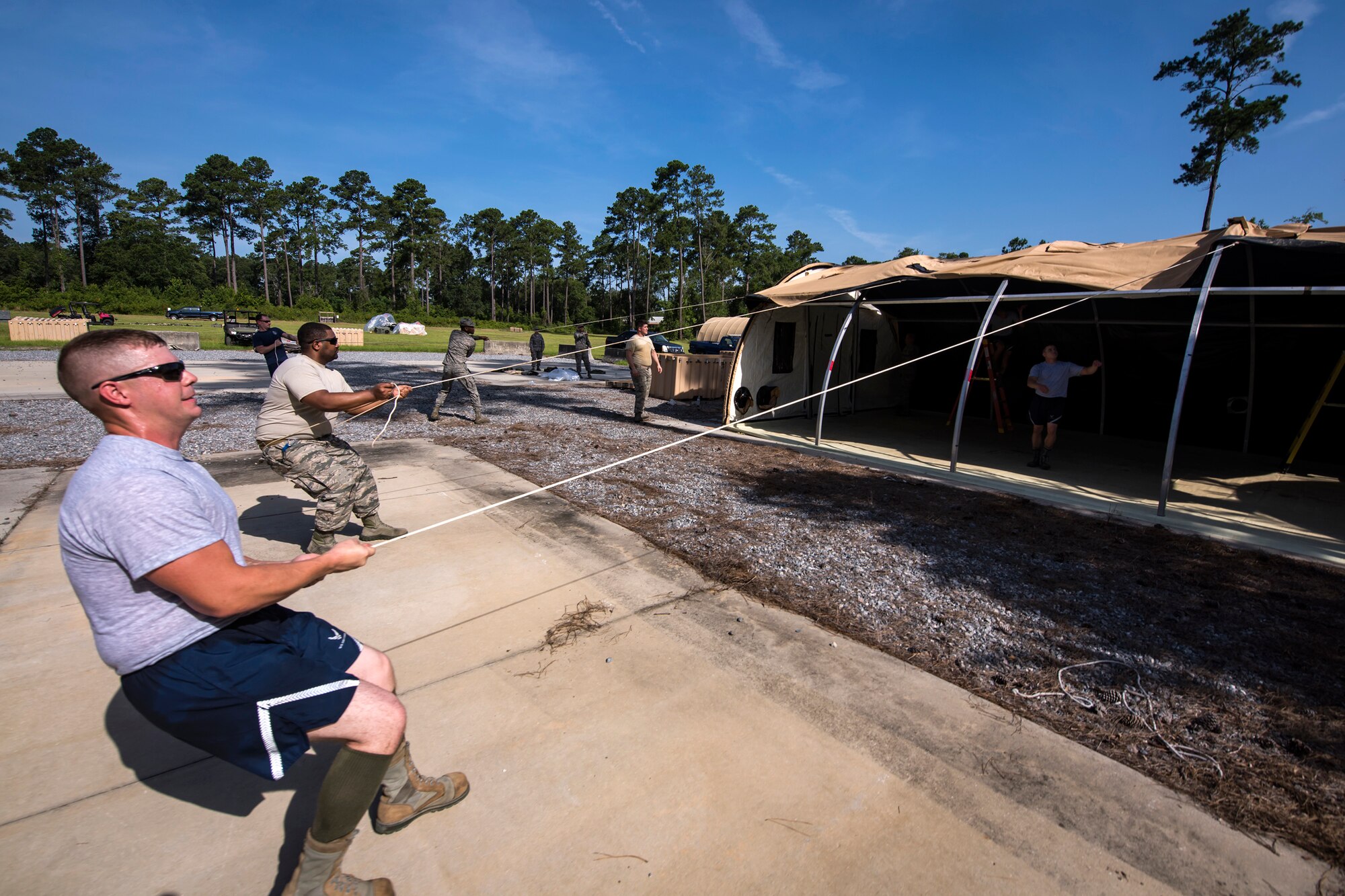 Airmen from the 23d Civil Engineer Squadron, pull a tarp over an Alaskan Small Shelter system during a Chemical, Biological, Radiological, Nuclear and Explosive (CBRNE) Olympics, June 21, 2018, at Moody Air Force Base, Ga. Moody held its first CBRNE Olympics to further Airmen’s overall knowledge on all of the aspects of CBRNE through a new method that was meant to establish a sense of competition and camaraderie. (U.S. Air Force photo by Airman 1st Class Eugene Oliver)