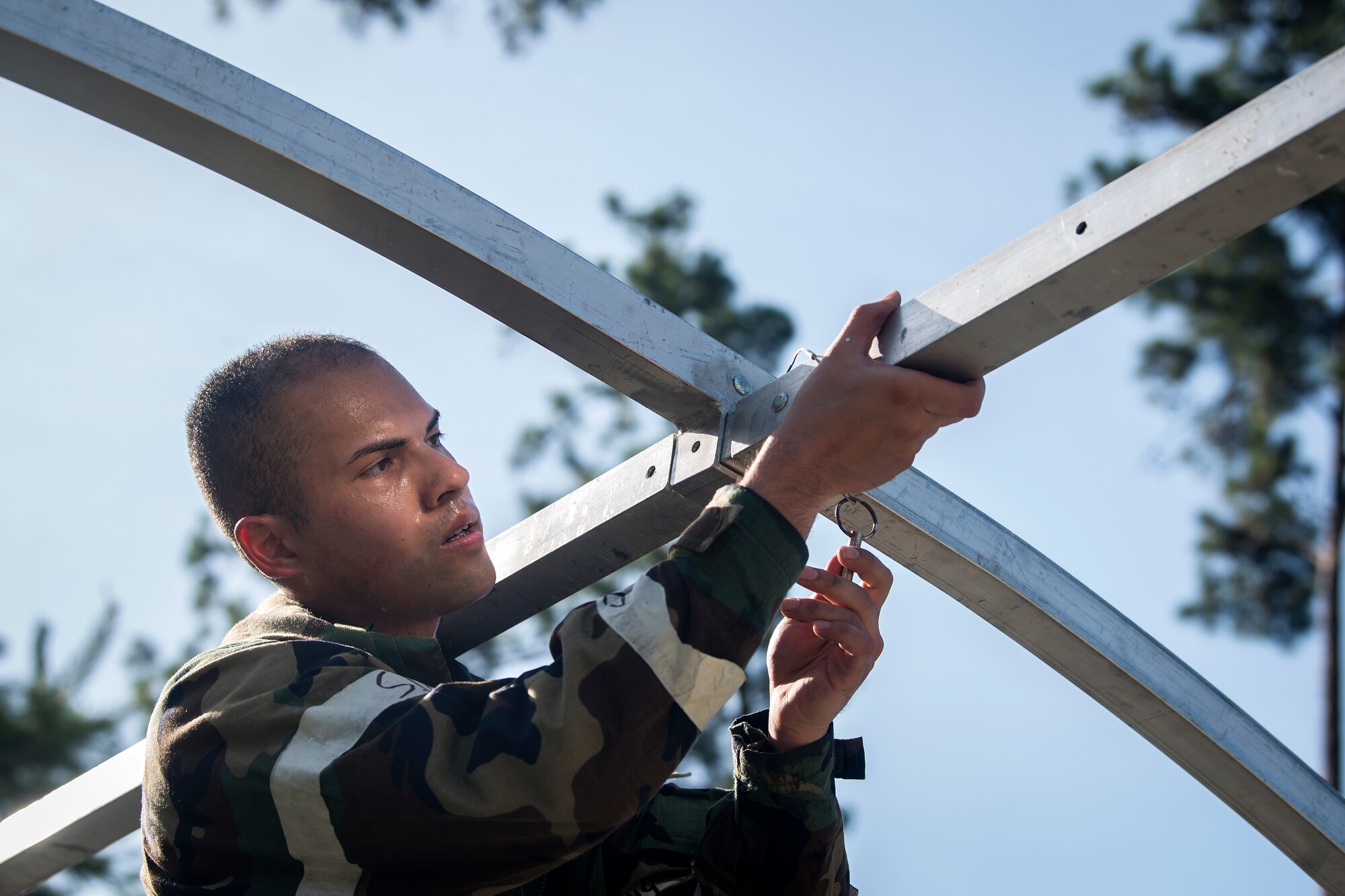 Airman First Class Phillip Pham, 23d Civil Engineer Squadron engineering assistant, assembles an Alaskan Small Shelter System during a Chemical, Biological, Radiological, Nuclear and Explosive (CBRNE) Olympics, June 21, 2018, at Moody Air Force Base, Ga.   Moody held its first CBRNE Olympics to further Airmen’s overall knowledge on all of the aspects of CBRNE through a new method that was meant to establish a sense of competition and camaraderie. (U.S. Air Force photo by Airman 1st Class Eugene Oliver)