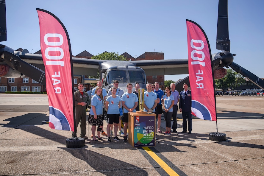 A Royal Air Force baton relay team from the 54th Signals Unit, RAF Digby, pose for a photograph during their visit to RAF Mildenhall, England, for the RAF 100 Baton Relay, June 29, 2018. The team is one of many who ran 54 kilometers at several bases during the relay. (U.S. Air Force photo by Senior Airman Christine Groening)