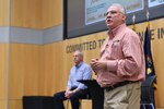 Javier Peña, right, and Steve Murphy share stories about leading the manhunt for drug lord Pablo Escobar with the Defense Intelligence Agency workforce, June 21.