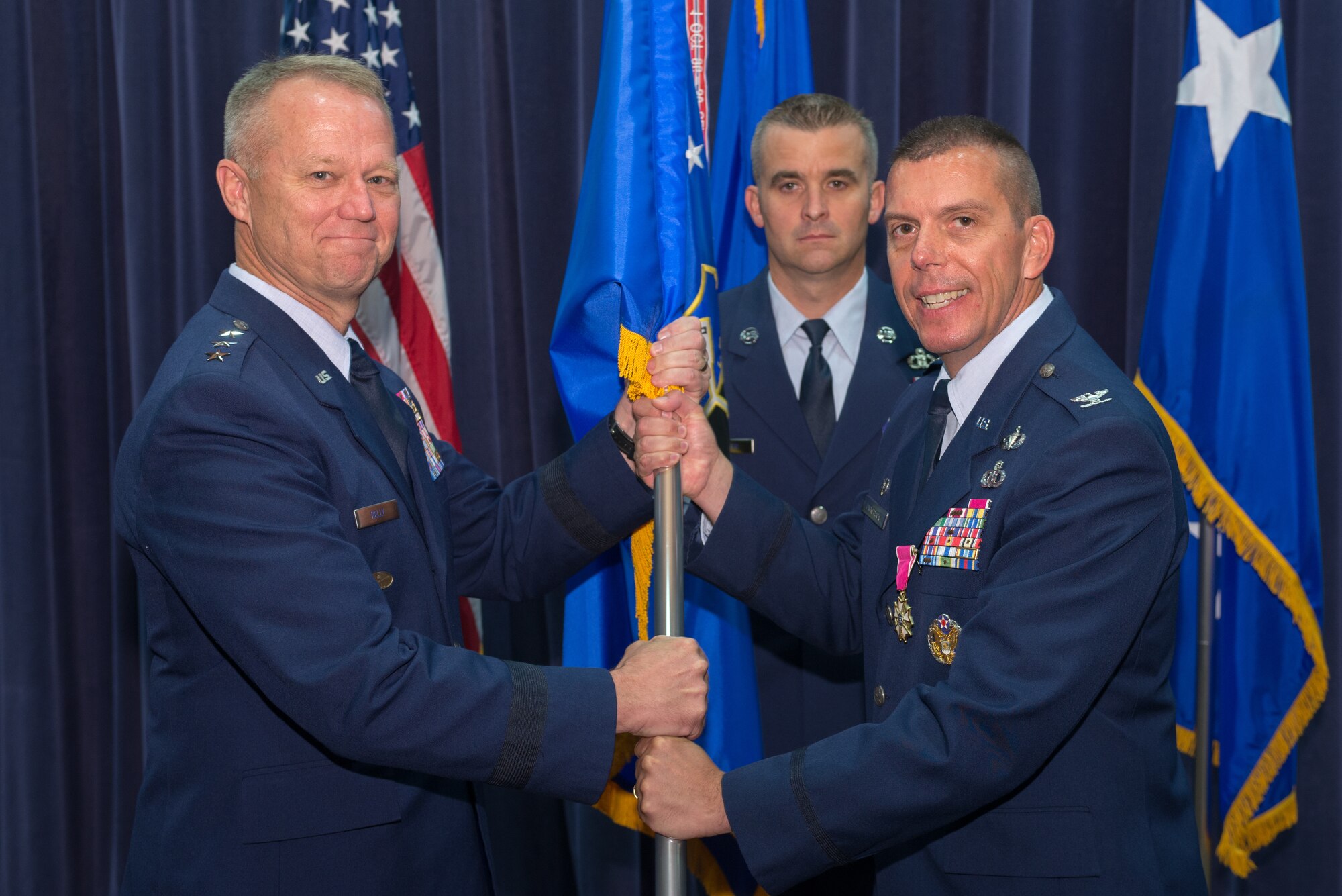 U.S. Air Force Col. Steven Dickerson, outgoing commander, 557th Weather Wing (WW), relinquishes the 557th WW to U.S. Air Force Lt. Gen. Mark Kelly, commander, 12th Air Force, during a change of command ceremony June 26, 2018, at Offutt Air Force Base, Nebraska. The 557th WW has 18 geographically-separated units located around the world. (U.S. Air Force photo by Paul Shirk)