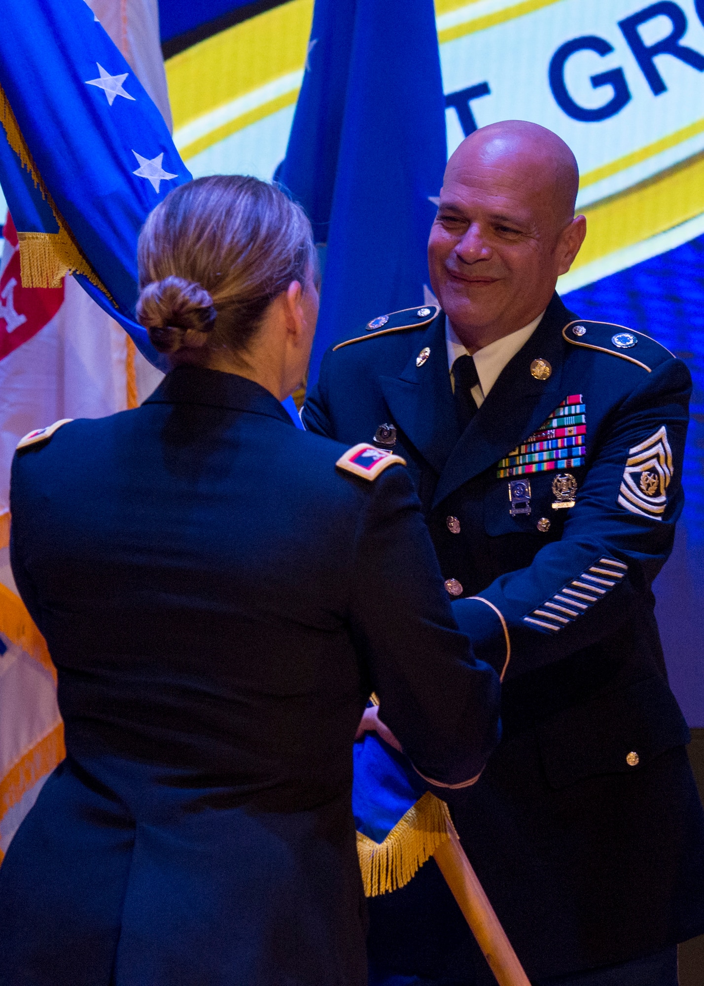 U.S. Army Command Sgt. Maj. Eric Vidal, 733rd Mission Support Group command sergeant major, right, passes the unit guidon to Col. Jennifer S. Walkawicz, 733rd Mission Support Group incoming commander, left, during a change of command ceremony at Joint Base Langley-Eustis, Va., June 29, 2018.