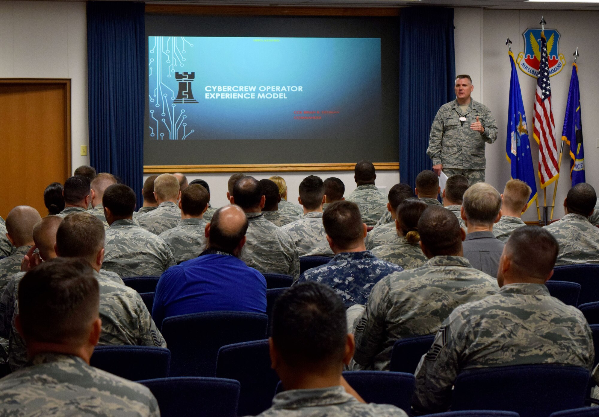 Col. Brian Denman, 567th Cyberspace Operations Group commander, briefs Cyber Protection Team Conference 18-1 attendees at Joint Base San Antonio-Lackland, Texas, June 26, 2018. The three day, 567th COG-hosted conference gathered Total Force and joint cyber professionals to share best practices to improve operational CPT effectiveness. U.S. Cyber Command CPTs defend national and DOD networks and systems against threats, as part of the combatant command’s Cyber Mission Force. (U.S. Air Force photo by Tech. Sgt. R.J. Biermann)