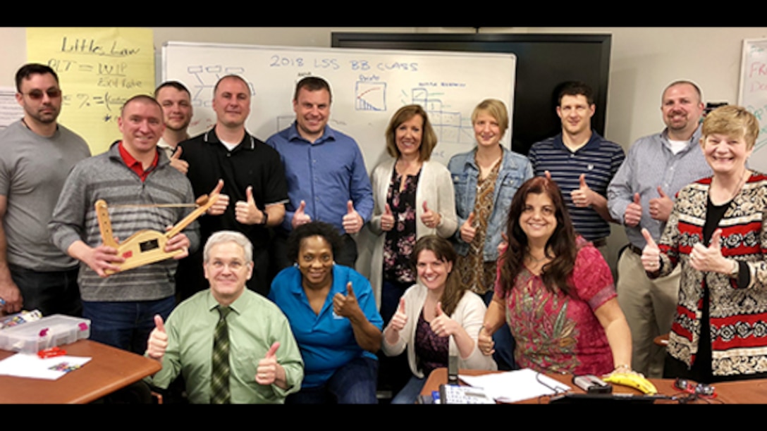 Marie Greening (far right), the Defense Contract Management Agency’s deputy director, congratulates 13 employees who graduated on April 27 after attending three weeks of onsite black belt training spread across three months. The goal is for these employees to lead teams to update business processes and find ways to achieve cost savings across the agency. (DCMA photo by DCMA Strategic Analysis and Planning Division)