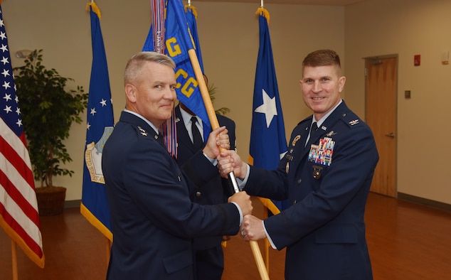 Col. Michael A. Sinks accepts command of the 844th Communications Group from Maj. Gen. James A Jacobson, Air Force District of Washington commander, during a change-of-command ceremony June 28 on Joint Base Andrews, Maryland.