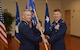 Col. Michael A. Sinks accepts command of the 844th Communications Group from Maj. Gen. James A Jacobson, Air Force District of Washington commander, during a change-of-command ceremony June 28 on Joint Base Andrews, Maryland.