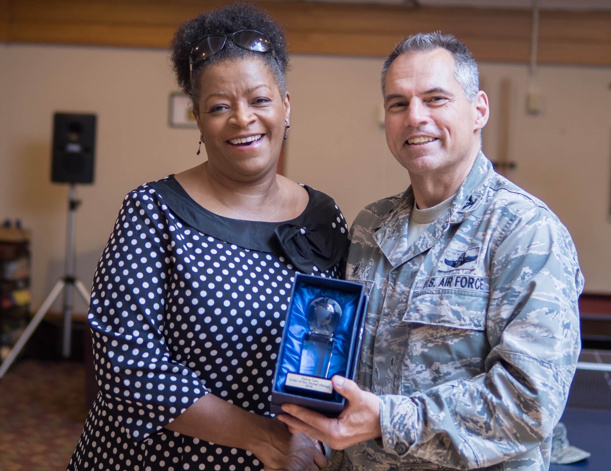 Debra Cain, director of the Minneapolis Armed Forces Services Center, accepts the Order of the Global Vikings award June 28 from Col. Tony Polashek, 934th Airlift Wing commander. (Air Force Photo/Paul Zadach)