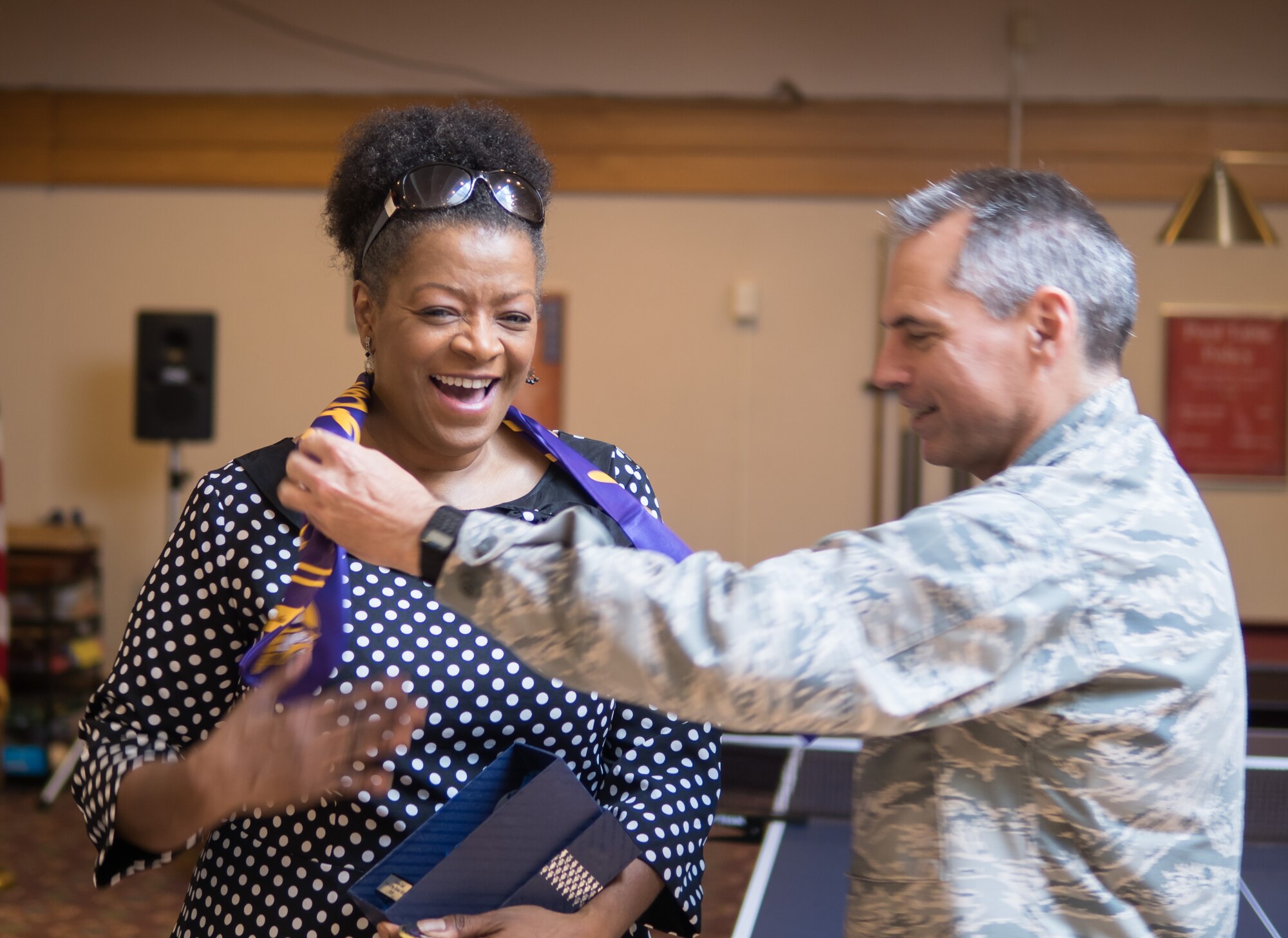 Debra Cain, director of the Minneapolis Armed Forces Services Center, accepts a Flying Viking aviator scarf June 28 from Col. Tony Polashek, 934th Airlift Wing commander. (Air Force Photo/Paul Zadach)