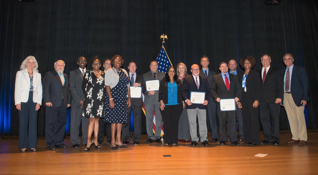 Value Engineering Achievement Award winners on stage at the Pentagon during June 28 ceremony.