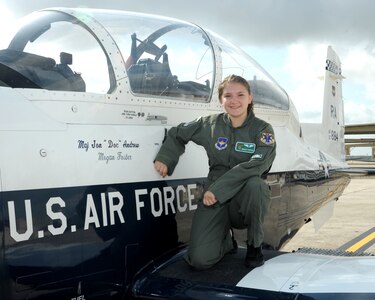 Megan Foster, sits on the wing of a T-6 Texan II, during her “Pilot for a Day” orientation at June 26, 2018, Joint Base San Antonio-Randolph, Texas.  The "Pilot for a Day" program invites children of all ages, military or civilian, to be guests of the 12th Flying Training Wing and its flying squadrons for an entire day. In so doing, the 12th FTW strives to give each child a special day and a break from the challenges they may face.  (U.S. Air Force photo by Joel Martinez/Released)