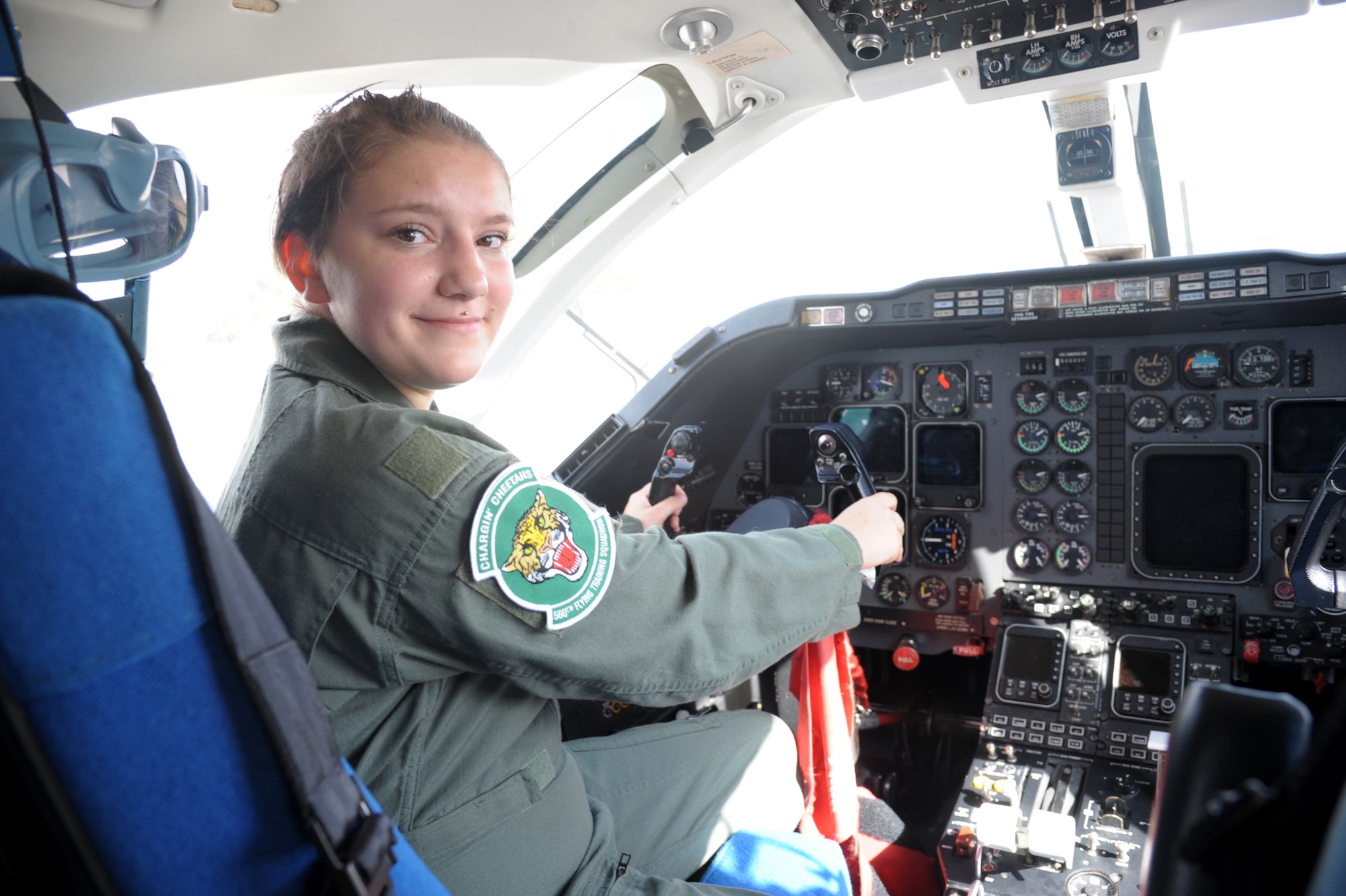 Megan Foster, sits on the cockpit of a T-1 Jayhawk, during her “Pilot for a Day” orientation at June 26, 2018, Joint Base San Antonio-Randolph, Texas.  The "Pilot for a Day" program invites children of all ages, military or civilian, to be guests of the 12th Flying Training Wing and its flying squadrons for an entire day. In so doing, the 12th FTW strives to give each child a special day and a break from the challenges they may face.  (U.S. Air Force photo by Joel Martinez/Released)