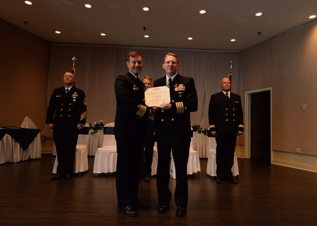 U.S. Navy Capt. Robert Hudson, right, is awarded the Legion of Merit in recognition for his accomplishments as Joint Base Charleston deputy commander and Naval Support Activity Charleston commander from U.S. Navy Capt. Kevin Byrne, Joint Base Charleston deputy commander ceremony June 29, 2018 at the Joint Base Charleston Weapons Station Red Bank Club.