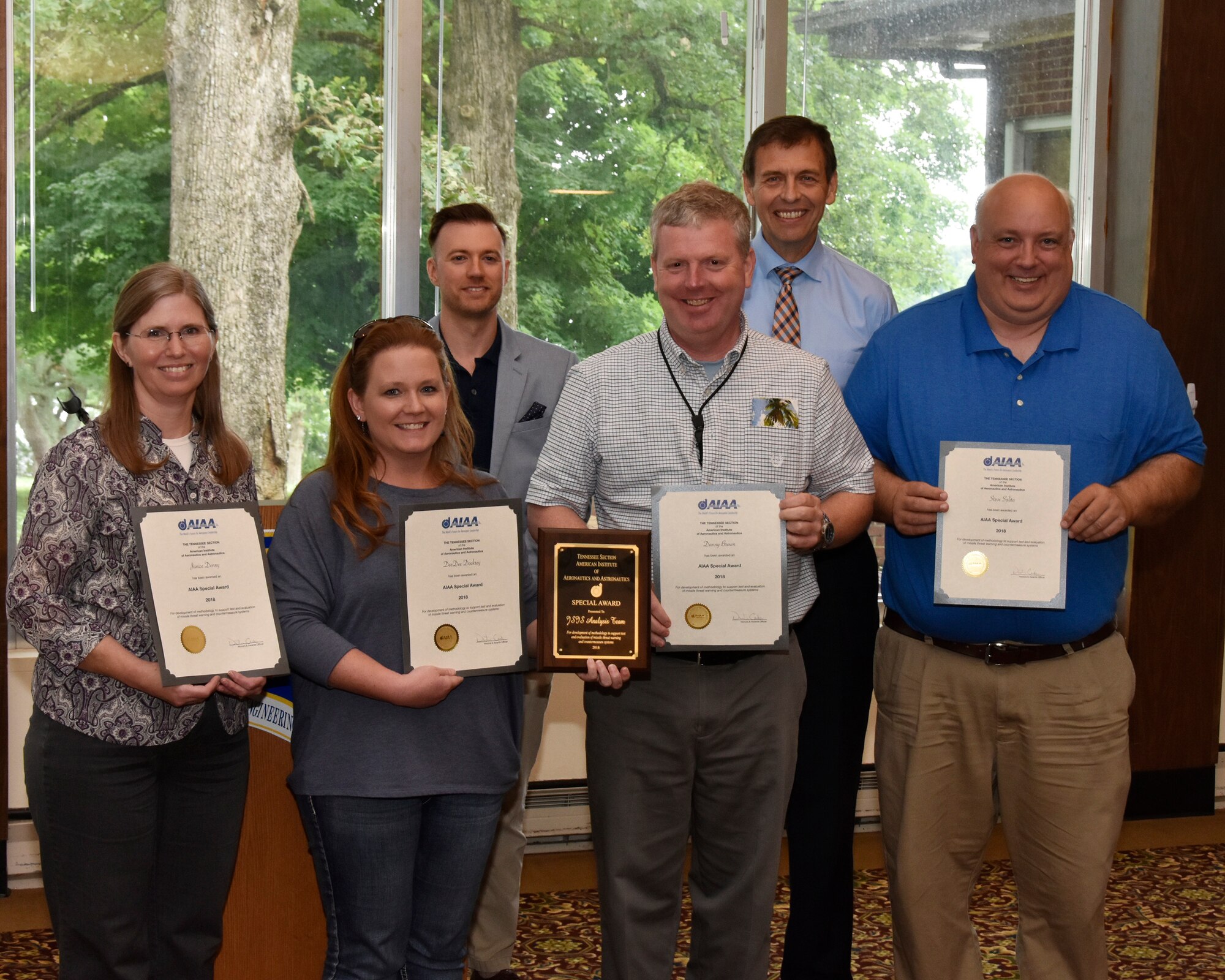 Janice Denny, Cherise Dockrey, Danny Brown, and Steve Salita (front row), all with AEDC, receive an AIAA Special Award from Dustin Crider (back left), AEDC and AIAA Tennessee Section Awards Chair, and nominator Rick Gamble (back right), AEDC, for development of methodology to support test and evaluation of missile threat warning and countermeasure systems. (U.S. Air Force photo/Rick Goodfriend)