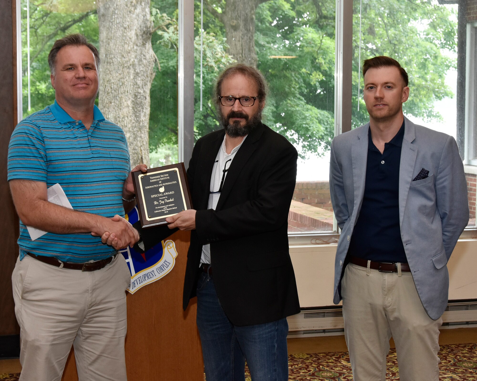 Dr. Jay Frankel (center), University of Tennessee Knoxville, receives an AIAA Special Award from Dr. Joseph Sheeley (left), AEDC, and Dustin Crider (right), AEDC and AIAA Tennessee Section Awards Chair, for development and validation of the Calibration Integral Equation Method. (U.S. Air Force photo/Rick Goodfriend)