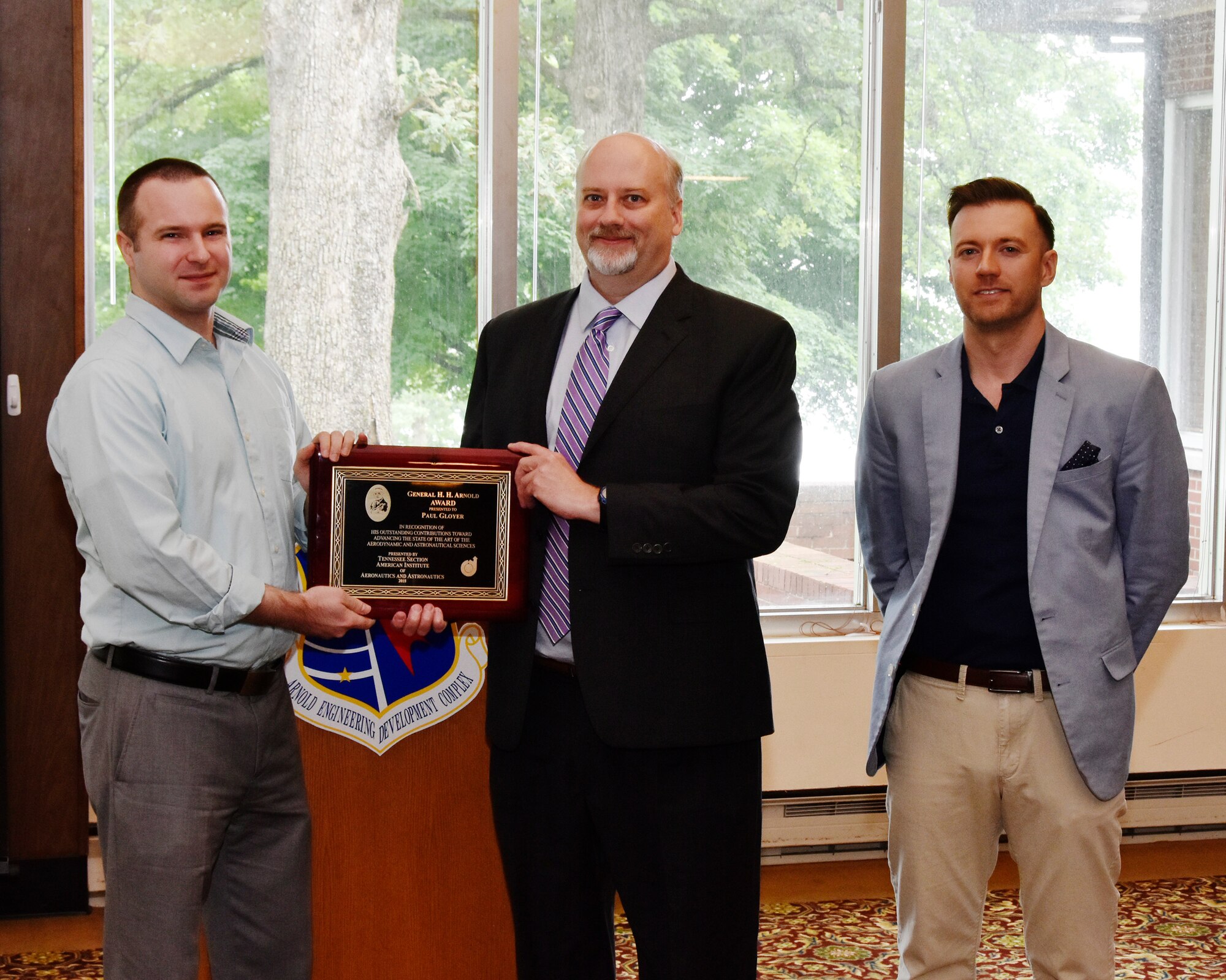 Paul Gloyer (center), with Gloyer-Taylor Laboratories, receives the General H.H. Arnold Award, from Dr. Joshua Batterson (left), also with Gloyer-Taylor Laboratories, and Dustin Crider (right), with AEDC and AIAA Tennessee Section Awards Chair, in recognition of his outstanding contributions toward advancing the state of the art of the aerodynamic and astronautical sciences. (U.S. Air Force photo/Rick Goodfriend)