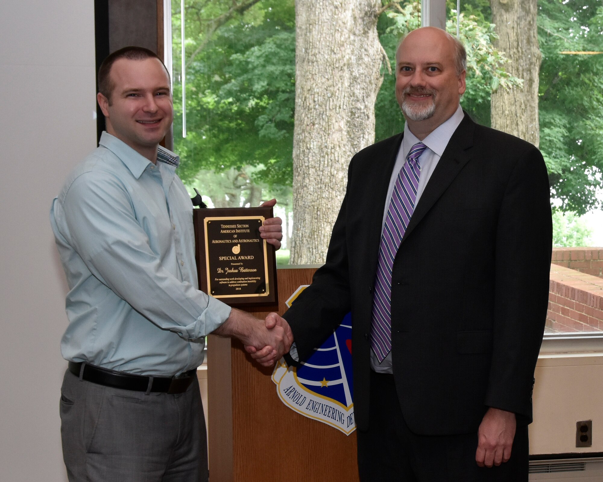 Dr. Joshua Batterson (left), with Gloyer-Taylor Laboratories, receives the AIAA Special Award from his nominator, Paul Gloyer (right), Gloyer-Taylor Laboratories, for outstanding work developing and implementing software to address combustion instability in propulsion systems. (U.S. Air Force photos/Rick Goodfriend)