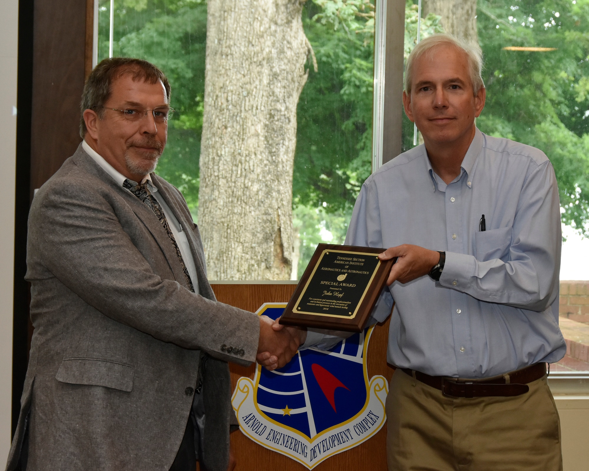 John Hopf (left), AEDC, receives an AIAA Special Award from one of his nominators, Stuart Coulter, AEDC retired, for consistent and outstanding professionalism and technical prowess in the execution of transonic and hypersonic wind tunnels testing. (U.S. Air Force photo/Rick Goodfriend)