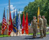 Maj. Gen. Richard Gallant (right), Lt. Gen. Jeffrey Buchanan (center front), Maj. Gen. William Hall (right) and CMSgt James Brown (center back) pass along the Joint Task Force Civil Support (JTF-CS) flag during a Change of Command ceremony on 29 June. The tradition symbolizes the passing of authority from the previous JTF-CS commander (Gallant) to the new commander (Hall), who is now the tenth commander of JTF-CS. JTF-CS provides command and control for designated Department of Defense specialized response forces to assist local, state, federal and tribal partners in saving lives, preventing further injury and providing critical support to enable community recovery. (Official DoD photo by Mass Communication Specialist 3rd Class Michael Redd/released)