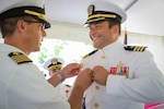 Cmdr. Matthew Myers, EXU-1’s inaugural commanding officer, receives his Command at Sea Insignia denoting his new status as a commanding officer.