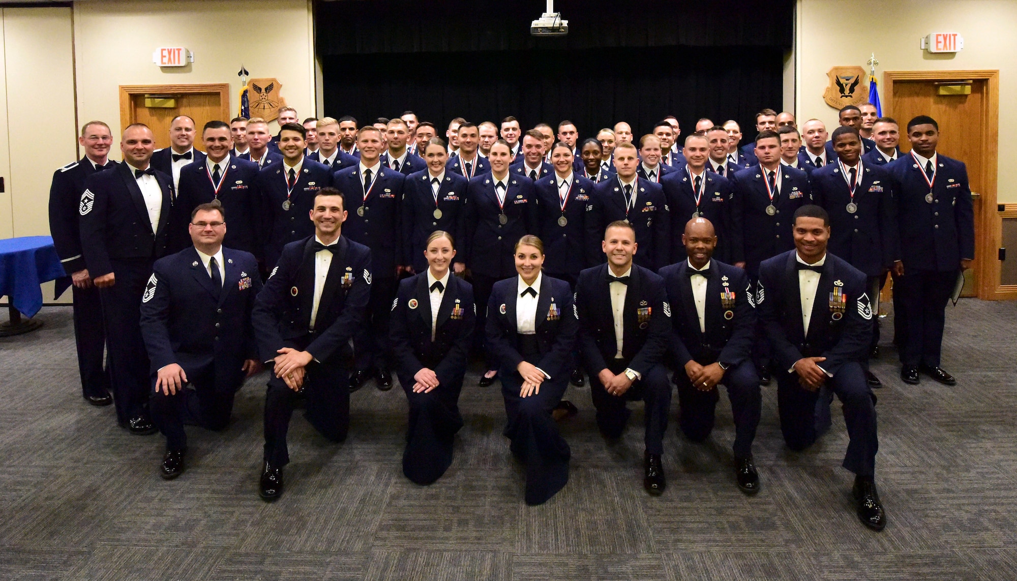 Whiteman Airman Leadership School Class 18-E gathers after their graduation ceremony at Whiteman Air Force Base, Missouri, June 21, 2018. Their class motto was: "It's not about how far you go, it's about how high you fly." The nearly six-week course provides students with tools to effectively lead Airmen. (U.S. Air Force photo by Staff Sgt. Danielle Quilla)