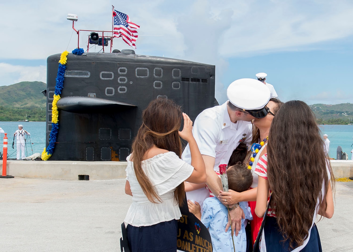 170629-N-PK553-220 SANTA RITA, Guam (June 29, 2018) Chief Electonics Technician Navigation Michael Levy receives a kiss from wife Crystal during a homecoming ceremony on the pier for Los-Angeles class fast attack submarine USS Oklahoma City (SSN 723), June 29. Oklahoma City is one of four forward-deployed submarines assigned to Commander, Submarine Squadron 15.  (U.S. Navy photo by Culinary Specialist Seaman Jonathan Perez)