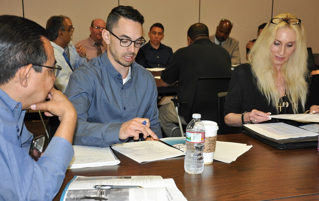 Joe Goldstein, Dam Safety program manager for the U.S. Army Corps of Engineers Los Angeles District, center, works with representatives from Los Angeles County on how the team would respond during a flood-risk tabletop exercise June 21 at the LA County Department of Public Works.