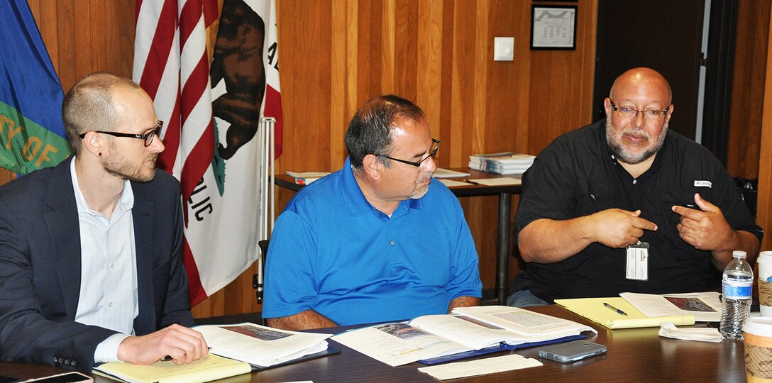 David Silvertooth, study manager and Southern California Silver Jackets coordinator with the Water Resources Planning Section, U.S. Army Corps of Engineers Los Angeles District, far left, listens to one of his team mates from Los Angeles County during a flood-risk tabletop exercise June 21 at the LA County Department of Public Works.
