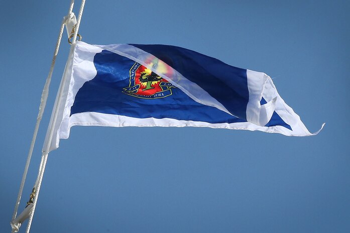 EXU-1's command flag flies for the first time during the ceremony.