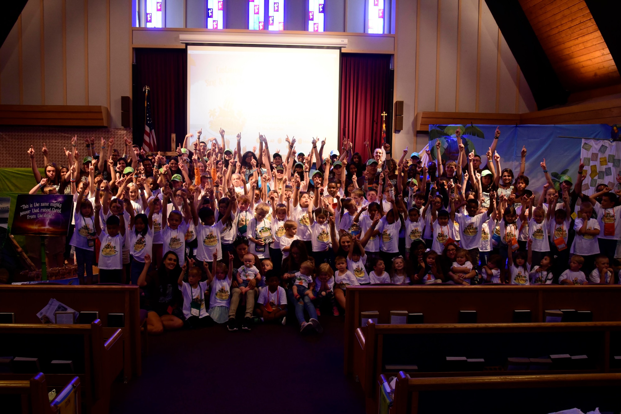 Vacation Bible School children and volunteers pose for a group photo June 29, 2018 at Fairchild Air Force Base, Washington. With focus on Christian-based beliefs, children spend this five-day youth program in various stations learning different lessons that fit snuggly into the overarching message of “Rescued by Jesus,” ultimately building resiliency through religion. (U.S. Air Force photo/Staff Sgt. Nick Daniello)