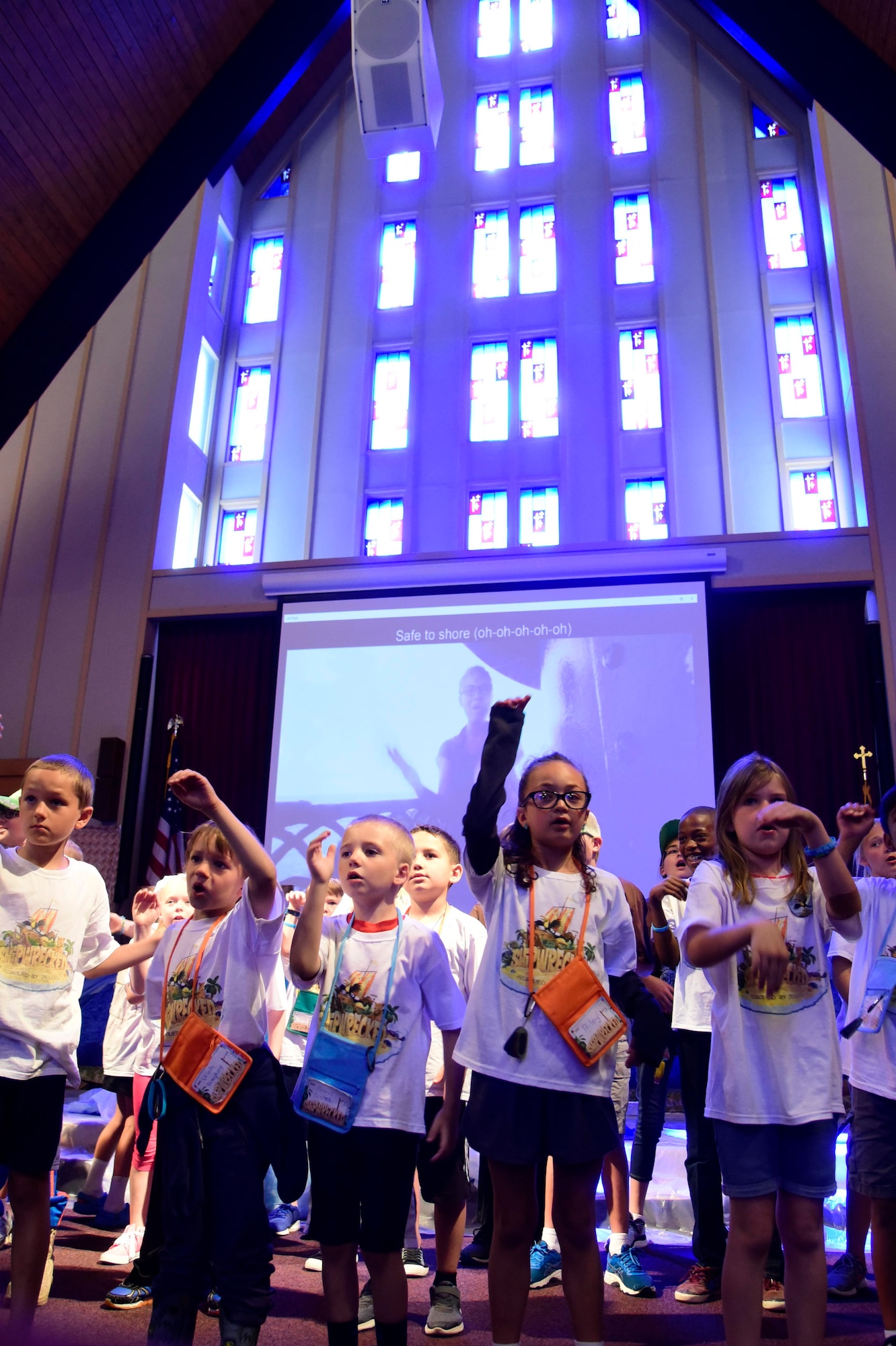 Children sing during Vacation Bible School June 29, 2018 at Fairchild Air Force Base, Washington. All of the activities that children participated in immersed them in faith development. These lessons are not limited to teaching bible verses and songs, they also give military children important tools to build upon their spiritual resilience in the face of the numerous challenges and stressors they encounter on an almost daily basis. (U.S. Air Force photo/Staff Sgt. Nick Daniello)