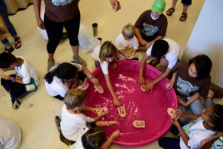 Children play with foam boats during Vacation Bible School June 29, 2018 at Fairchild Air Force Base, Washington. Children participated in four daily activity stations during the five-day Vacation Bible School, learning about the teachings of the Bible. These lessons also gave military children important tools to build their spiritual resilience in the face of the numerous challenges and stressors they encounter on an almost daily basis. (U.S. Air Force photo/Staff Sgt. Nick Daniello)