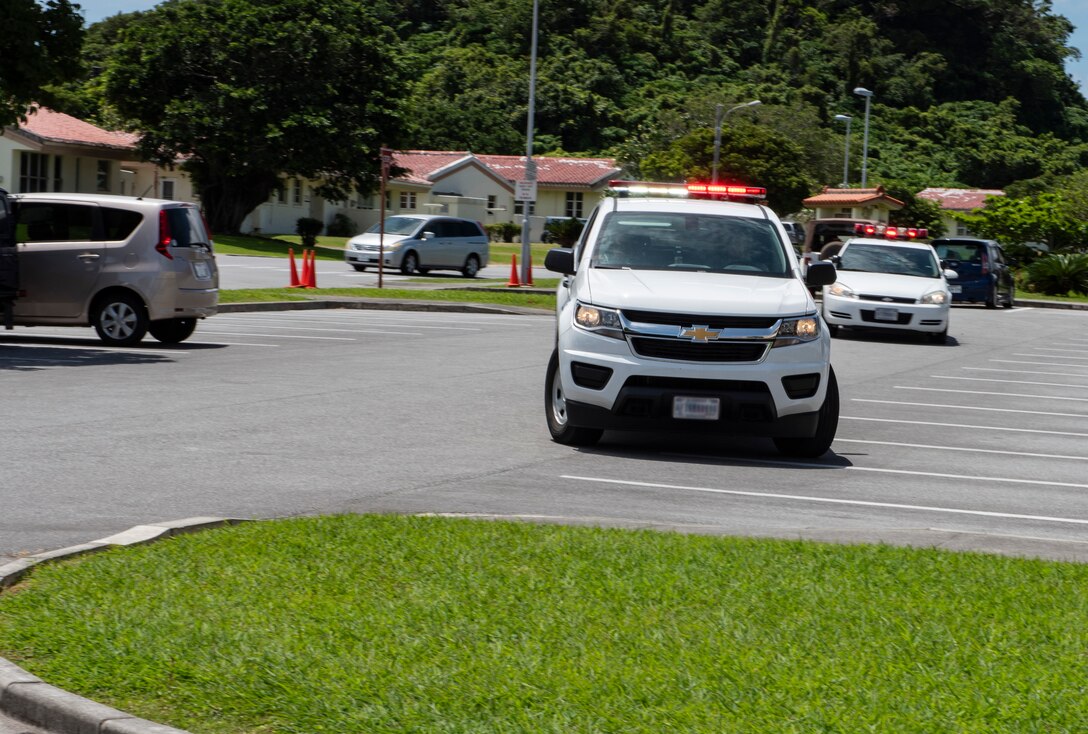 Defenders from the 18th Security Forces Squadron respond to a simulated active shooter exercise June 25, 2018, at Ryukyu Middle School, Kadena Air Base, Japan. The exercise enabled 18th SFS defenders to work with a U.S. Marine Corps special reaction team and the Kadena Fire Department to hone their skills. (U.S. Air Force photo by Staff Sgt. Micaiah Anthony)
