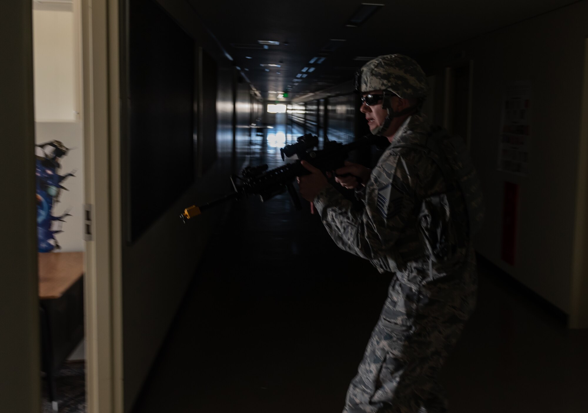 U.S. Air Force Master Sgt. Matthew Bridge, 18th Security Forces Squadron Alpha Flight chief, prepares to clear a room during an active shooter training exercise June 25, 2018, at Ryukyu Middle School, Kadena Air Base, Japan. The training enabled defenders to test new equipment, practice communication and coordination techniques. (U.S. Air Force photo by Staff Sgt. Micaiah Anthony)