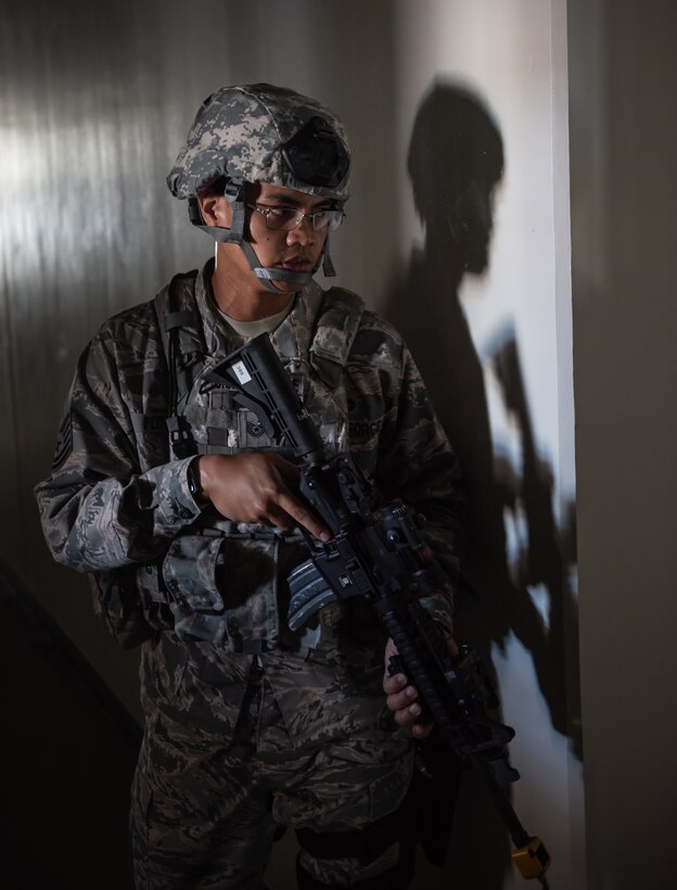 U.S. Air Force Tech. Sgt. Michael Flores, 18th Security Forces Squadron assistant Alpha Flight chief, confronts a simulated active shooter during a training exercise June 25, 2018, at Ryukyu Middle School, Kadena Air Base, Japan.  The training enabled defenders to test new equipment, practice communication and coordination techniques. (U.S. Air Force photo by Staff Sgt. Micaiah Anthony)