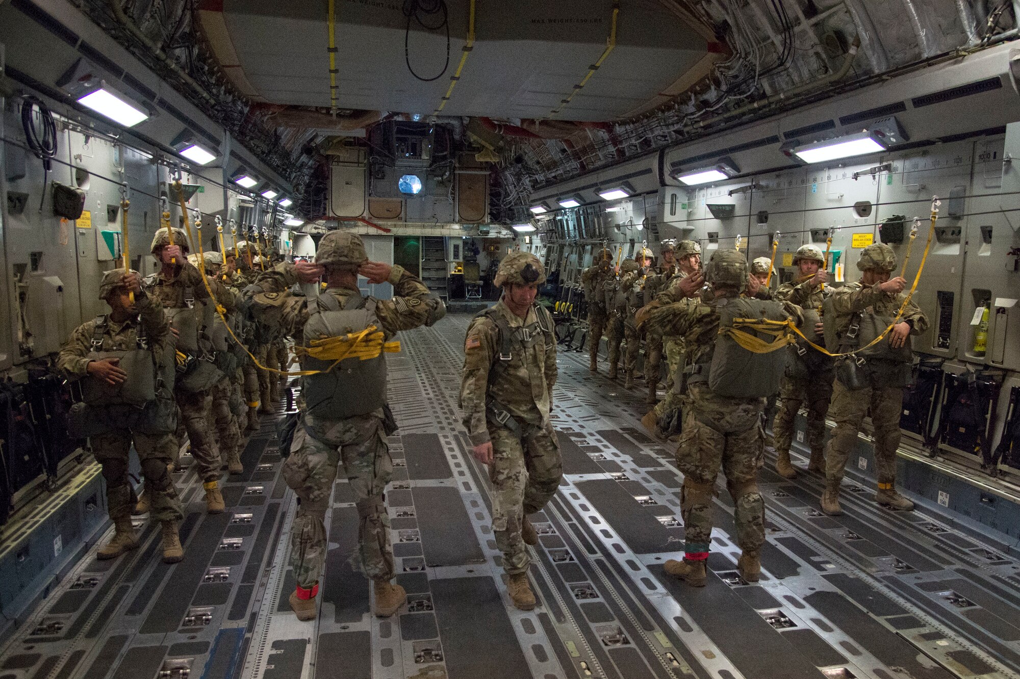 Paratroopers with the 4th Infantry Brigade Combat Team (Airborne), 25th Infantry Division, U.S. Army Alaska, prepare to jump out of a C-17 Globemaster III during the Arctic Thunder Open House Special Needs and Department of Defense Family Day at Joint Base Elmendorf-Richardson, Alaska, June 29, 2018. During the biennial open house, JBER opens its gates to the public and hosts multiple performers including the U.S. Air Force Thunderbirds, JBER Joint Forces Demonstration and the U.S. Air Force F-22 Raptor Demonstration Team.