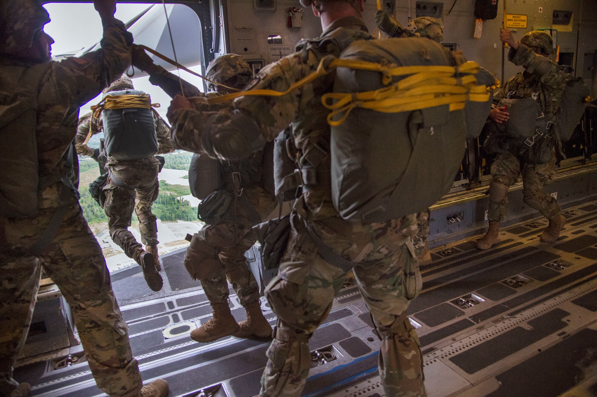 Paratroopers with the 4th Infantry Brigade Combat Team (Airborne), 25th Infantry Division, U.S. Army Alaska, jump out of a C-17 Globemaster III during the Arctic Thunder Open House Special Needs and Department of Defense Family Day at Joint Base Elmendorf-Richardson, Alaska, June 29, 2018. During the biennial open house, JBER opens its gates to the public and hosts multiple performers including the U.S. Air Force Thunderbirds, JBER Joint Forces Demonstration and the U.S. Air Force F-22 Raptor Demonstration Team.
