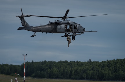 U.S. Air Force pararescuemen from the Alaska Air National Guard 212th Rescue Squadron perform a rescue demonstration during the Arctic Thunder Open House Special Needs and Department of Defense Family Day at Joint Base Elmendorf-Richardson, Alaska, June 29, 2018. During the biennial open house, JBER opens its gates to the public and hosts multiple performers including the U.S. Air Force Thunderbirds, JBER Joint Forces Demonstration and the U.S. Air Force F-22 Raptor Demonstration Team.