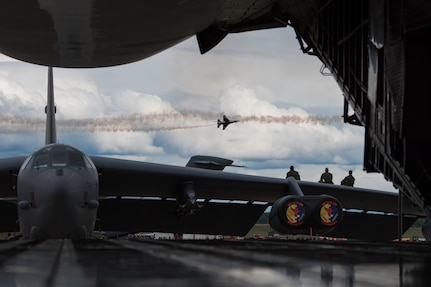 Aircrew assigned to the 5th Bomb Squadron, Minot Air Force Base, North Dakota, watch the U.S. Air Force Thunderbirds perform during the Arctic Thunder Open House Special Needs and Department of Defense Family Day at Joint Base Elmendorf-Richardson, Alaska, June 29, 2018. During the biennial open house, JBER opens its gates to the public and hosts multiple performers including the U.S. Air Force Thunderbirds, JBER Joint Forces Demonstration and the U.S. Air Force F-22 Raptor Demonstration Team.