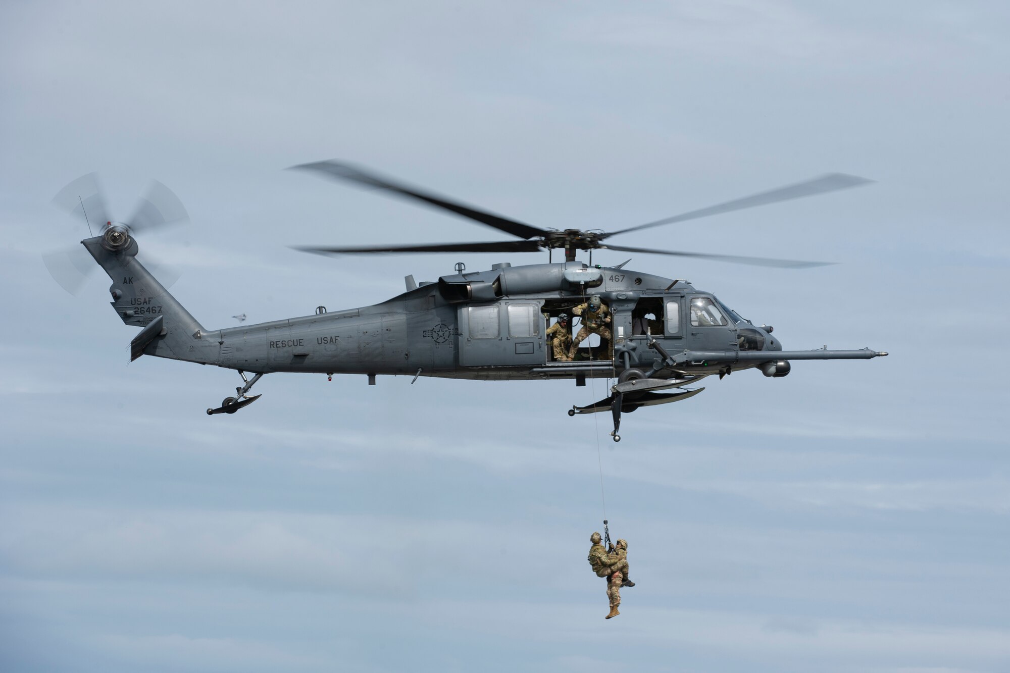 U.S. Air Force pararescuemen from the Alaska Air National Guard 212th Rescue Squadron perform a rescue during the Joint Forces Demonstration at the Arctic Thunder Open House on JBER, Alaska, June 30, 2018. During the biennial open house, JBER opens its gates to the public and hosts multiple performers including the U.S. Air Force Thunderbirds, JBER Joint Forces Demonstration and the U.S. Air Force F-22 Raptor Demonstration Team.
