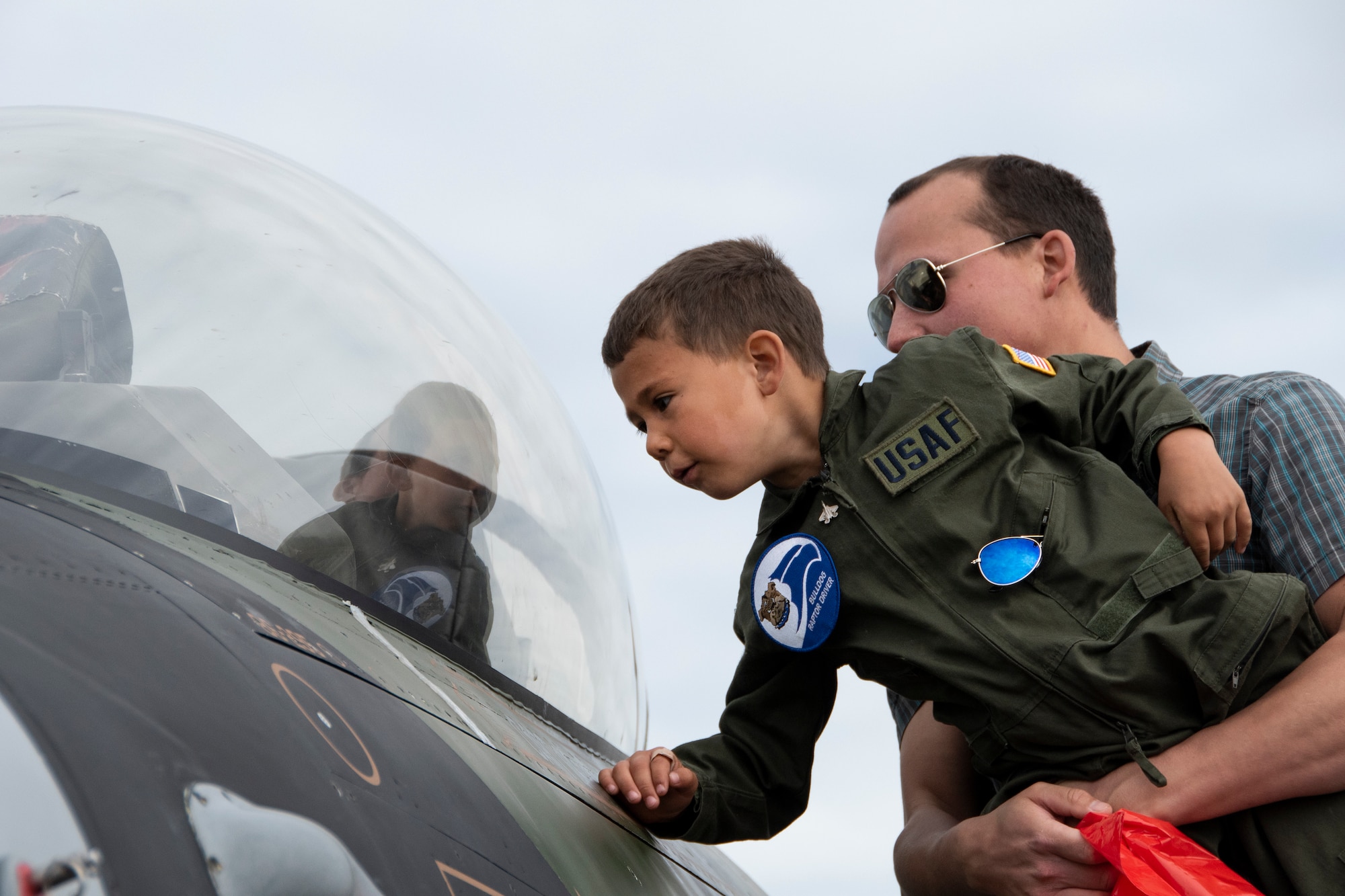 John Nadell and son, Alexander, 6, look inside the cockpit of an F-16 Fighting Falcon during Arctic Thunder Open House on Joint Base Elmendorf-Richardson, Alaska, June 30, 2018. During the biennial open house, JBER opens its gates to the public and hosts multiple performers including the U.S. Air Force Thunderbirds, JBER Joint Forces Demonstration and the U.S. Air Force F-22 Raptor Demonstration Team.