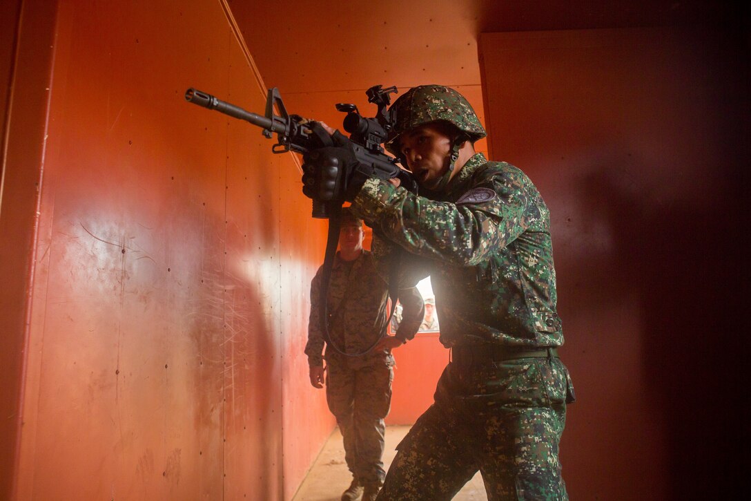 180628-M-ZO893-0121 MARINE CORPS BASE HAWAII (June 28, 2018) A Philippine Marine clears a room during urban operations training as part of Rim of the Pacific (RIMPAC) exercise aboard Marine Corps Base Hawaii June 28, 2018. RIMPAC provides high-value training for task-organized, highly-capable Marine Air-Ground Task Force and enhances the critical crisis response capability of U.S. Marines in the Pacific. Twenty-five nations, more than 45 ships and submarines, about 200 aircraft, and 25,000 personnel are participating in RIMPAC from June 27 to Aug. 2 in and around the Hawaiian Islands and Southern California. (U.S. Marine Corps photo by Sgt. Zachary Orr)