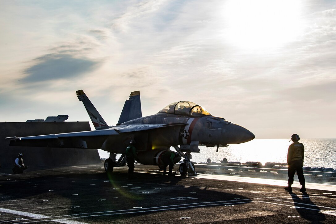 An F/A-18F Super Hornet prepares to take off from the flight deck of the aircraft carrier USS Carl Vinson.