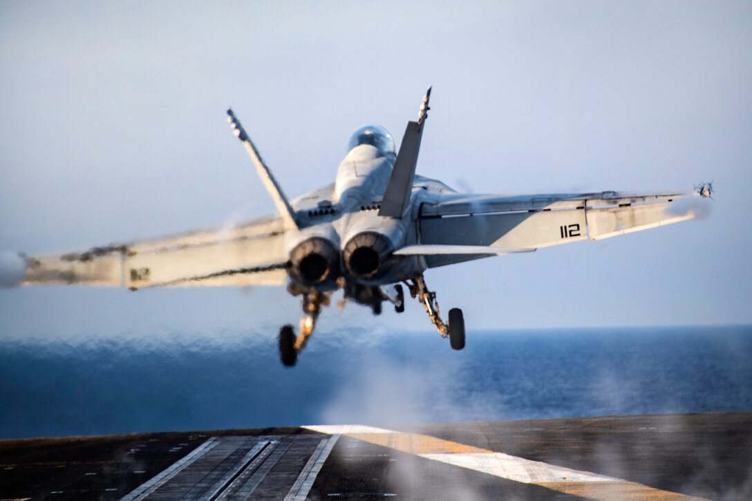 An F/A-18F Super Hornet takes off from the flight deck of the aircraft carrier USS Carl Vinson.