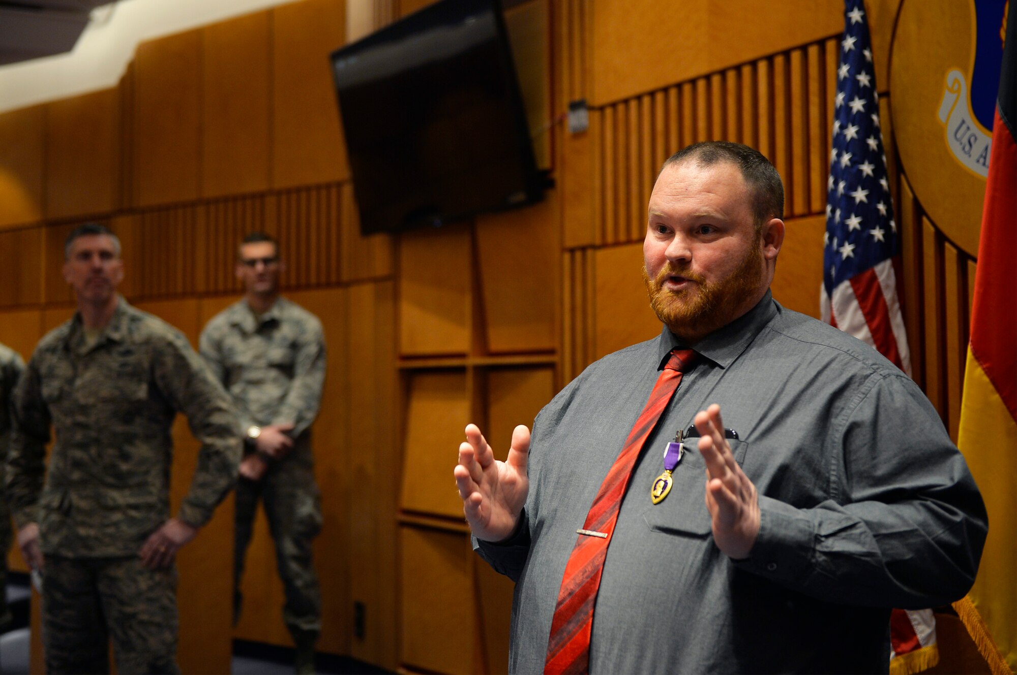 Judson Rackley, U.S. Air Forces in Europe-Air Forces Africa video operations center communications engineer, gives remarks after receiving the Purple Heart on Ramstein Air Base, Germany, Feb. 27, 2018. Rackley received the decoration for wounds he received in combat as a U.S. Army Soldier in Afghanistan in 2010. (U.S. Air Force photo by Senior Airman Joshua Magbanua)